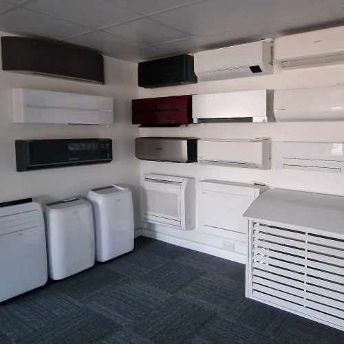 The Climachill showroom displaying a variety of air conditioning units mounted on the walls and portable units on the floor, showcasing different models and styles in a neatly organised space.